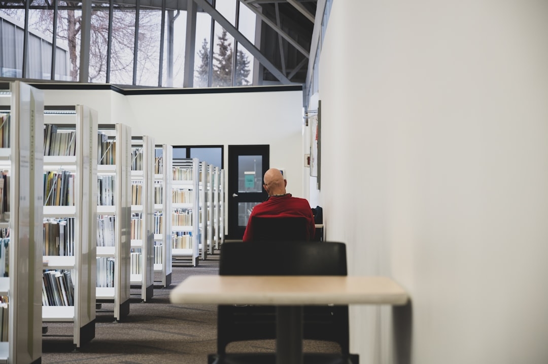 man in red shirt sitting on chair