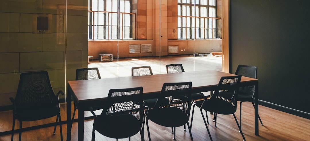 rectangular brown wooden dining table and black steel chairs