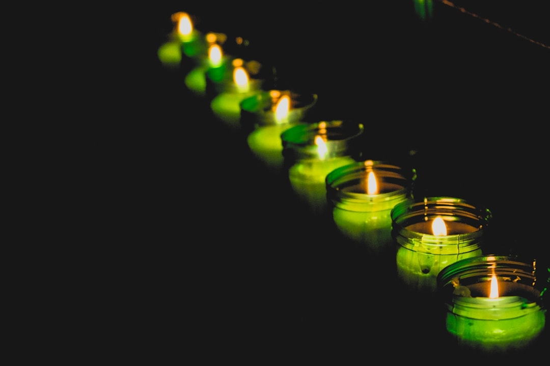 green glass candle holder with candles