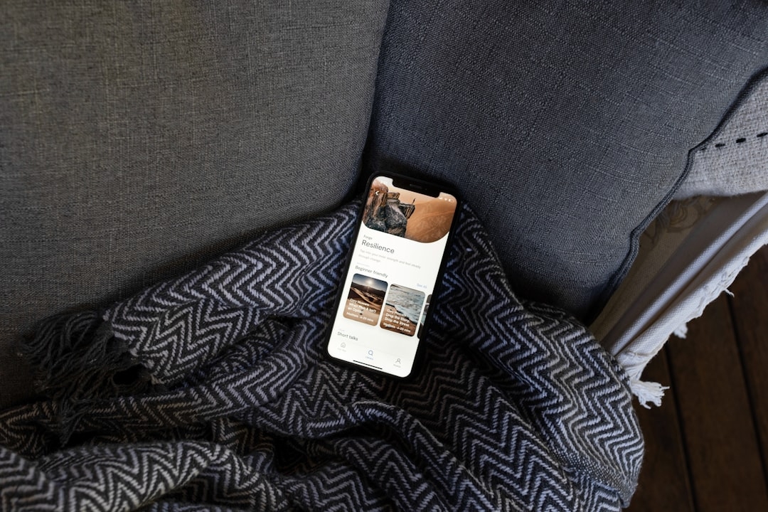 a gray chair with a black and white blanket on it