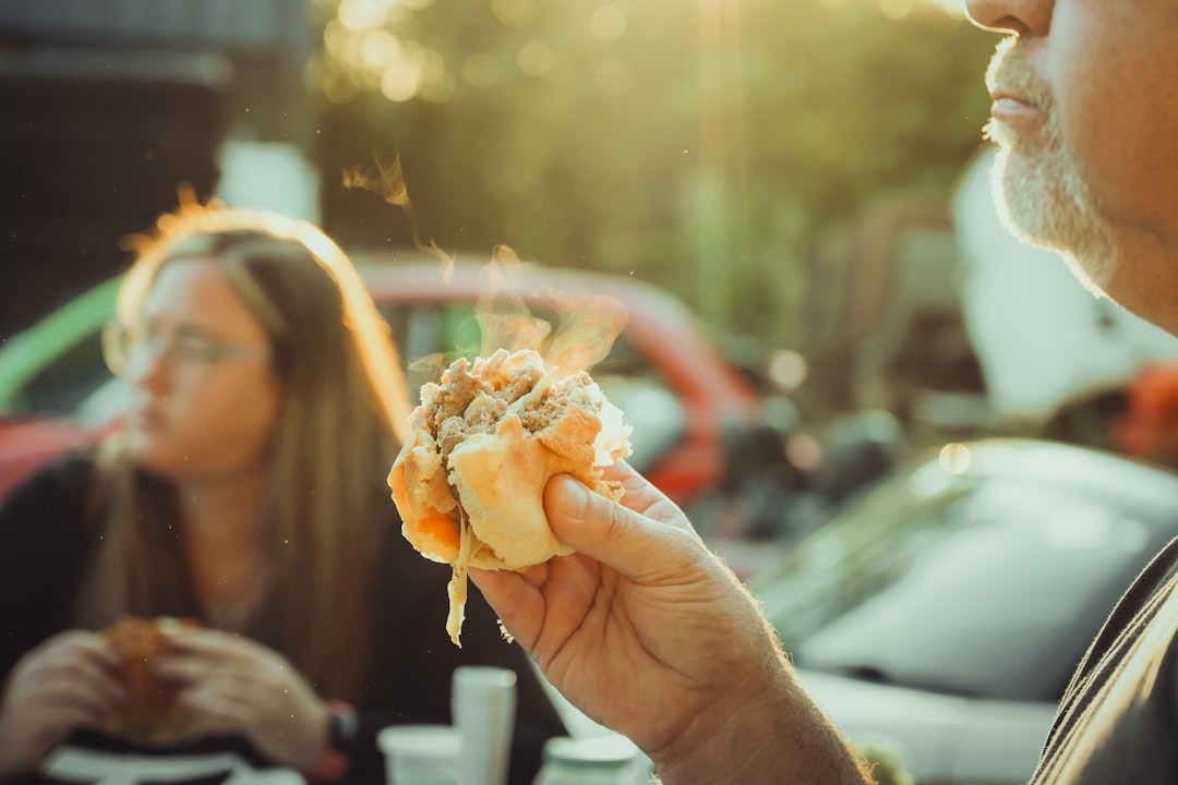 a man holding a hot dog in his hand