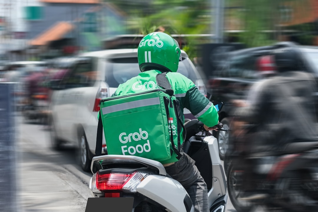 a person riding a motorcycle with a backpack on the back