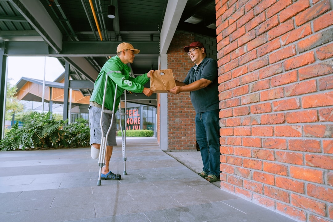 a man in a green jacket and a man in a blue shirt are holding a