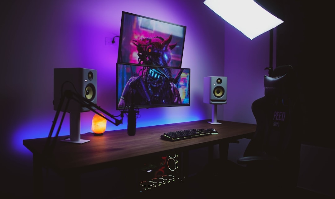 a desk with a monitor and speakers on it