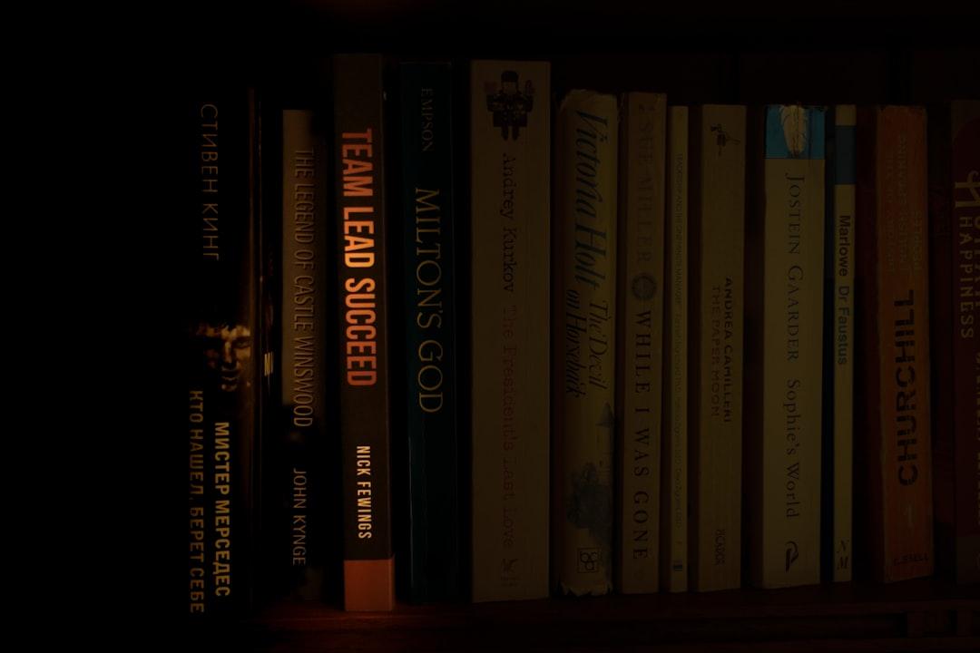 a bookshelf filled with lots of books in a dark room