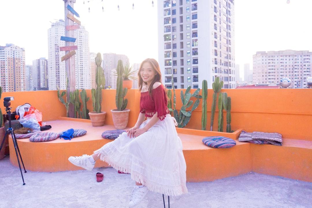 girl in white dress sitting on blue mat